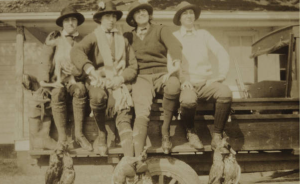 Belle Baruch, far right, with three guests have returned to headquarters at the hunt cabin at Clambank with a few pairs of ducks on display. c. 1910